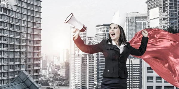Concept of power and sucess with businesswoman superhero in big city — Stock Photo, Image