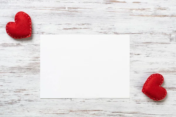 Blank sheet of paper and red love hearts — Stock Photo, Image