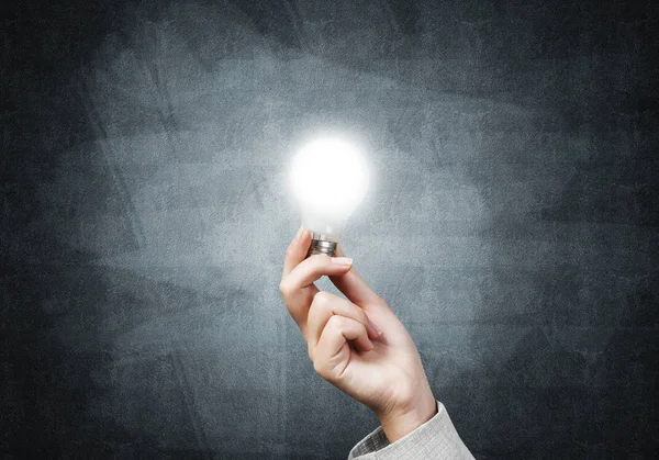 Human hand with glowing incandescent lamp — Stock Photo, Image