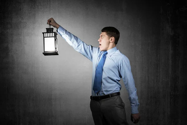 Horrified Businessman Holding Glowing Lantern Background Grunge Wall Young Emotional — Stock Photo, Image