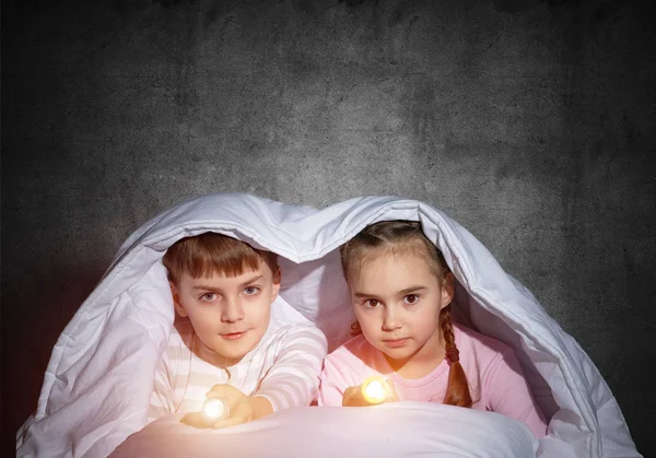 Children Flashlights Lying Bed Looking Camera Little Sister Brother Hiding — Stock Photo, Image