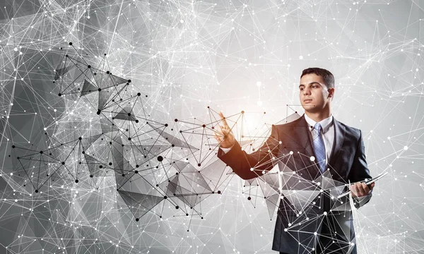 Business person pointing on abstract network structure. Standing personal assistant in business suit and tie on white background. Social connection and networking. Global cloud technology.