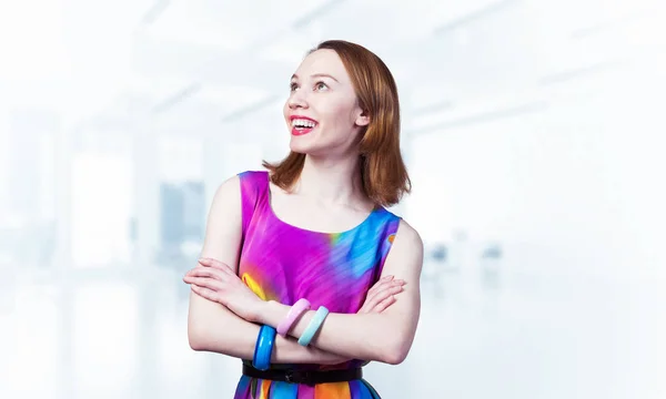 Smiling woman standing with folded arms — Stock Photo, Image