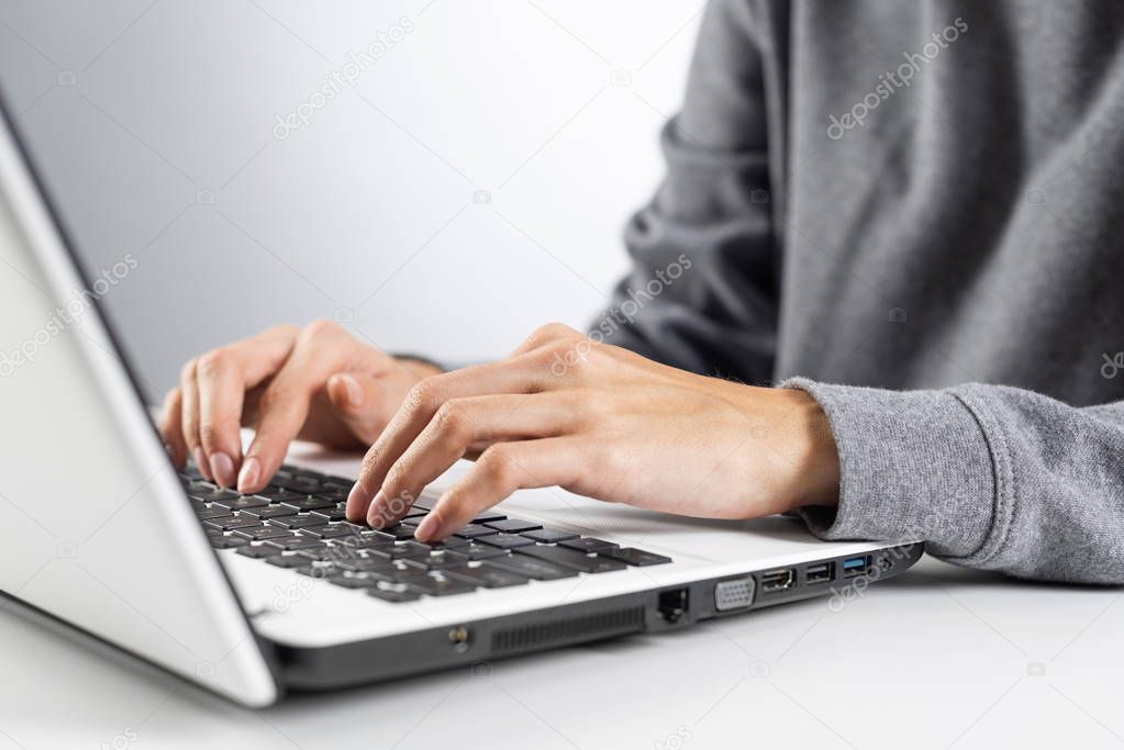 Student sitting at desk and working at laptop