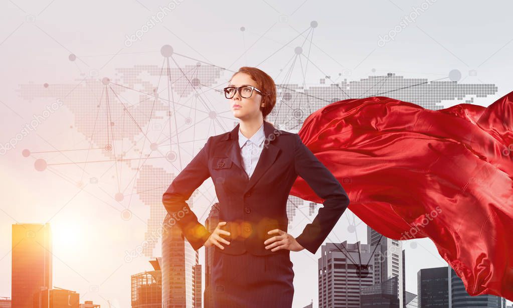 Concept of power and sucess with businesswoman superhero in big city