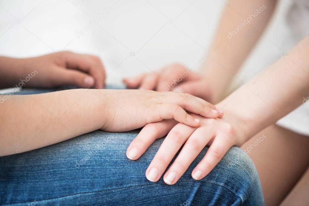 Close-up hands of little girl and her mother