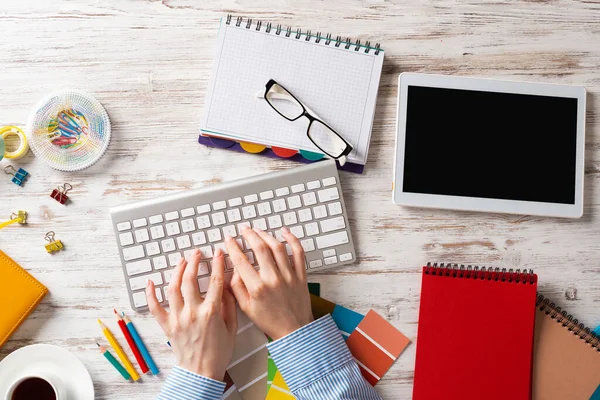 Woman designer typing on keyboard