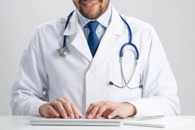 Kablosuz bilgisayar klavyesinde yazan erkek doktor