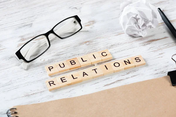 Public relations concept met letters op blokjes — Stockfoto