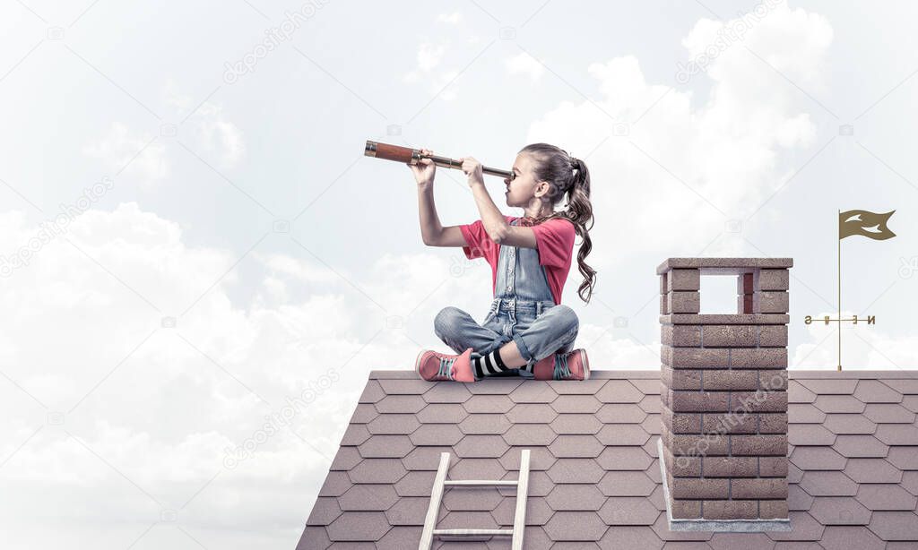 Concept of careless happy childhood with girl looking in spyglass