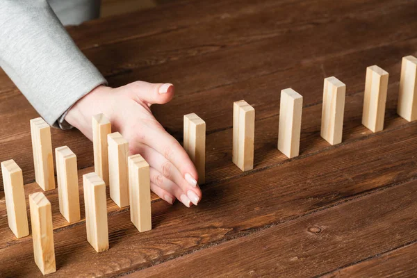 Business woman block domino effect. — Stock fotografie