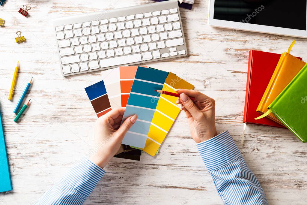Interior designer choosing colors from swatches