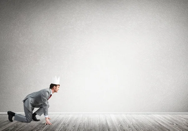 King businessman in elegant suit running in empty room — Stock Photo, Image