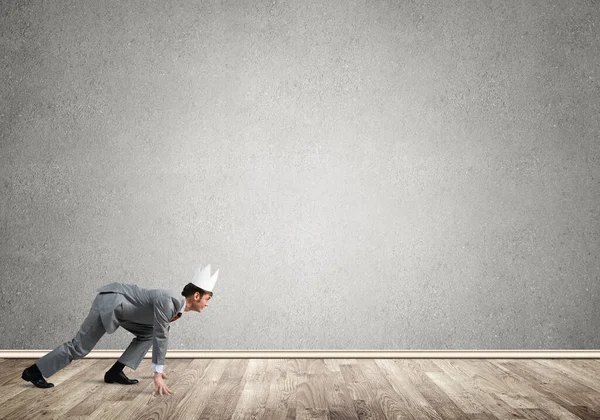 King businessman in elegant suit running in empty room — Stock Photo, Image