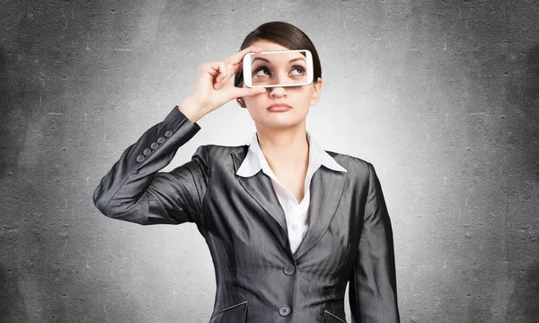 Woman covering her eyes with smartphone — Stock Photo, Image