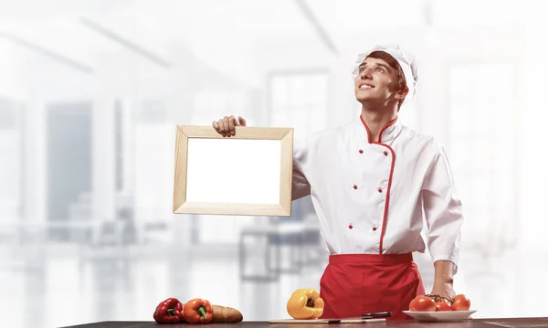 Young Male Chef Standing Cooking Table Holding Blank White Board — Stock Photo, Image