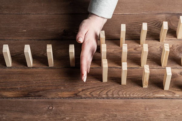 Businesswoman Protecting Dominoes Falling Wooden Desk Business Assistance Leadership Crisis — Stock Photo, Image