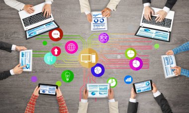 Ellerinde cihazlar bulunan bir grup insan, iletişim ve ağın sembolü olarak birlikte çalışıyor.