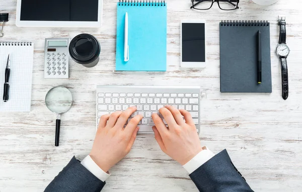 Businessman hands working at vintage wooden desk