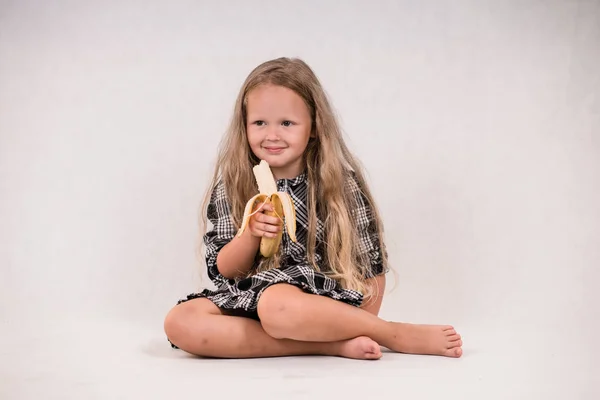 Beautiful Cute Little Girl Eating Delicious Healthy Banana White Background — Stock Photo, Image