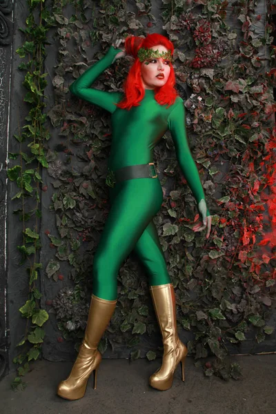 Όμορφη Νεαρή Γυναίκα Κόκκινα Μαλλιά Θέτοντας Πράσινο Κοστούμι Κοντά Φύλλα — Φωτογραφία Αρχείου