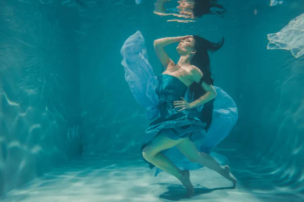 Schönes Model Mädchen Mit Langen Schwarzen Haaren Schwimmt Blauen Abendkleid — Stockfoto