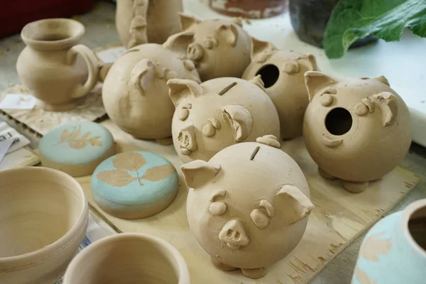 preparation of piggy mpney Bank in the form of raw clay in a pottery workshop