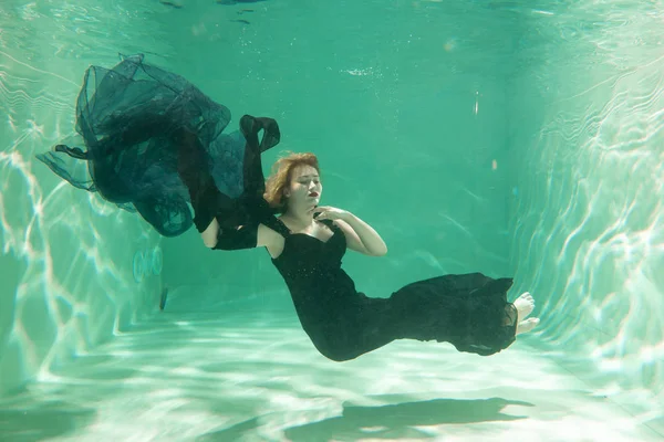 İnce beyaz kadın poz altında sıcak su derinlikleri giysileri yalnız