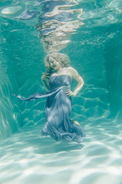 胖乎乎的性感的女人在灰色晚长礼服游泳水下她的假期 享受与放松 — 图库照片