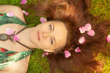 Kızıl saçlı alternatif kız güneşli elma bahçesi traş yürüyüşleri ile bir güneşli yaz gününde gülümseyen