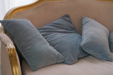 sıcak bej kanepe üzerinde gri yastık