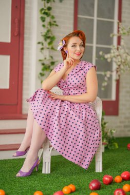 Kız seksi pembe polka dot elbise ve vintage çorap onu eve girişine yakın poz güzel kızıl saçlı PIN