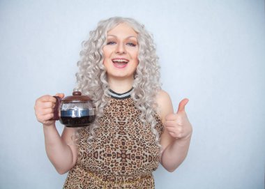 sevimli beyaz tombul kız ile bir su ısıtıcısı ellerini beyaz bir stüdyo düz arka plan günü kahvaltıda taze demlendi kahve