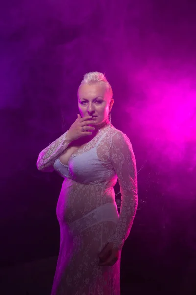 胖乎乎的性感的女人穿着白色性感蕾丝礼服和内衣在烟雾 — 图库照片