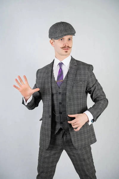 vintage English man with a checkered business suit on a white studio solid background