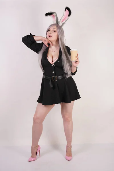 cute chubby anime girl with a coffee in a paper Cup on a white background in the Studio