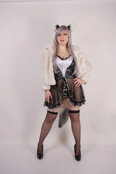 pretty plump woman wearing sexy lingerie dress and black stockings with furry anime ears and big fluffy tail on white background