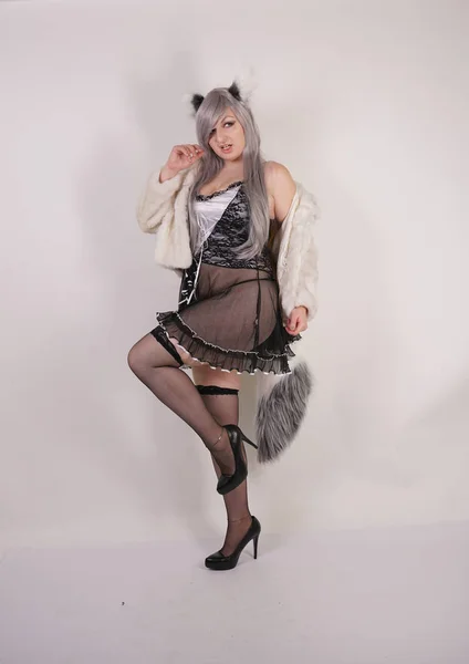 pretty plump woman wearing sexy lingerie dress and black stockings with furry anime ears and big fluffy tail on white background