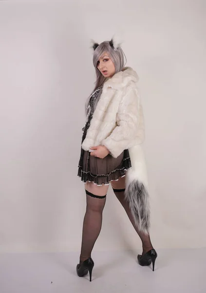 pretty plump woman wearing sexy lingerie dress and black stockings with furry anime ears and big fluffy tail on white background