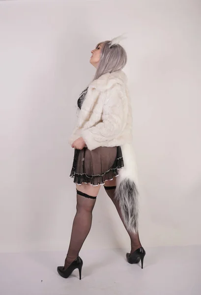 pretty plump woman wearing sexy lingerie dress and black stockings with furry anime ears and big fluffy tail on white background