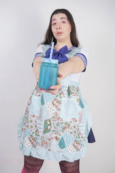 charming plus size anime girl in school uniform and an apron on top with a blue can of drink on white background