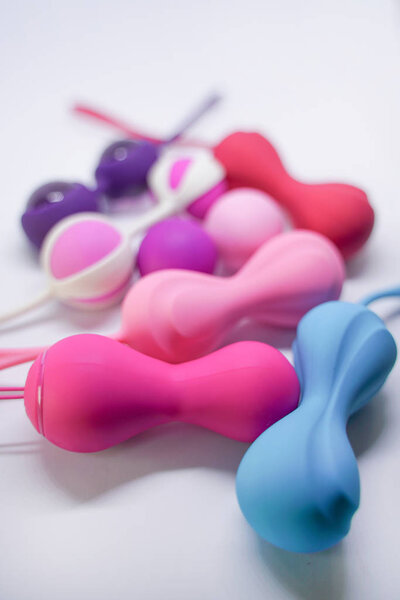 Bright sex toys on white background in the studio 