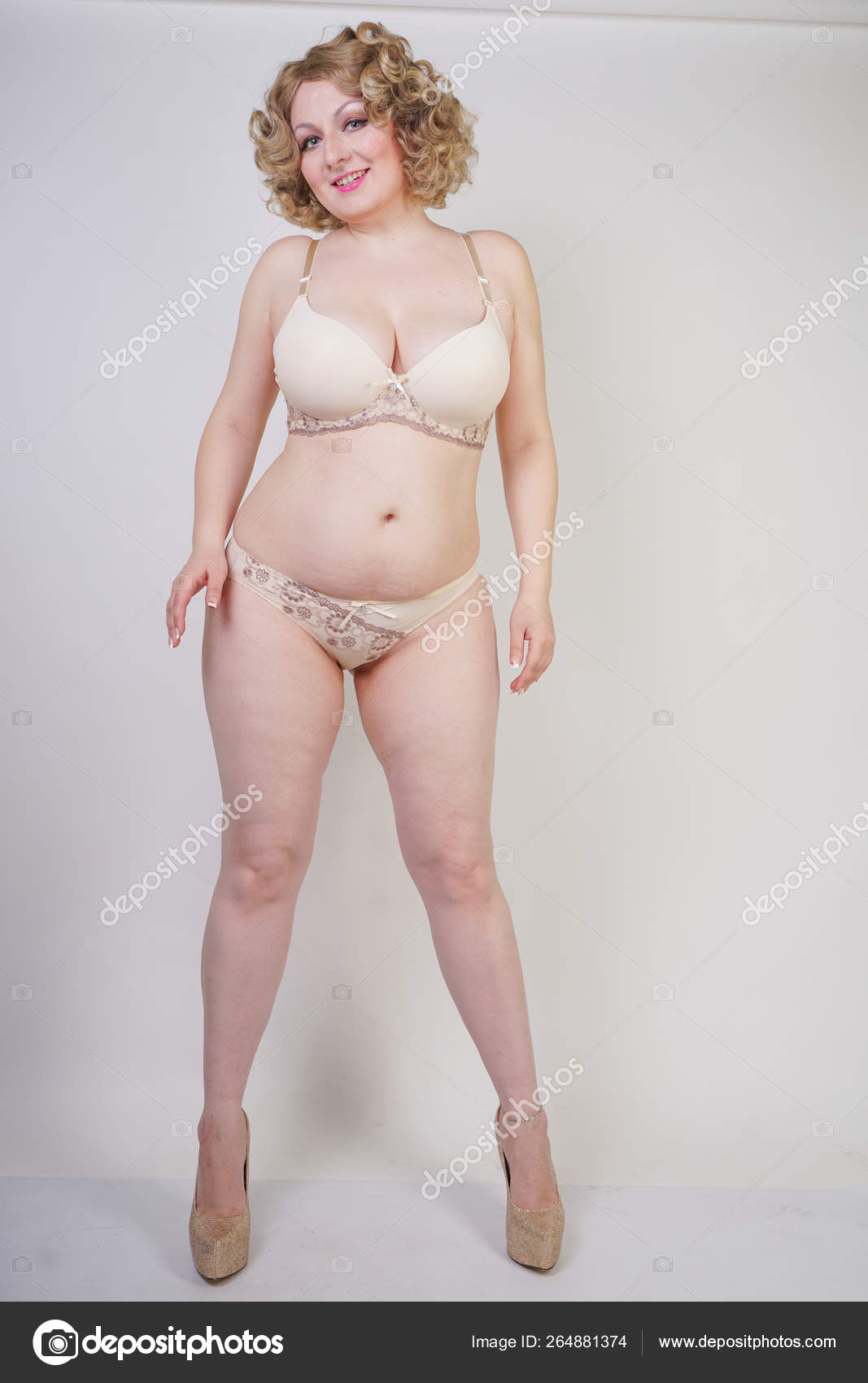 feminine chubby woman with plus size body in black lingerie posing