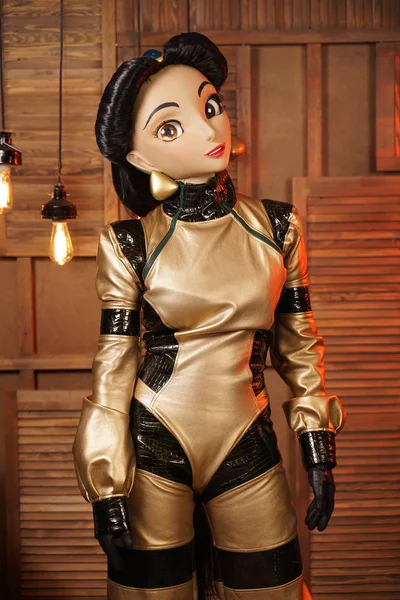 beautiful girl with full face mask doll in leather space jumpsuit posing in her room with light bulbs alone