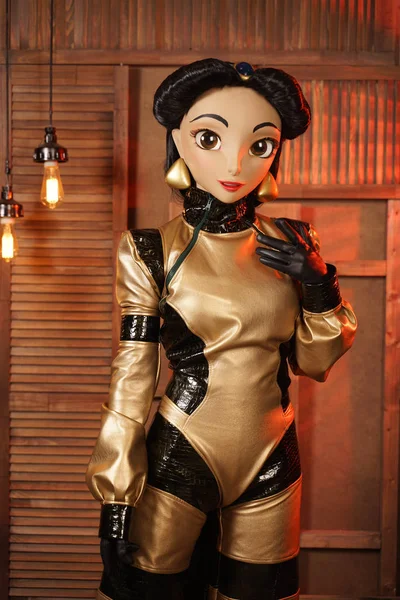 beautiful girl with full face mask doll in leather space jumpsuit posing in her room with light bulbs alone