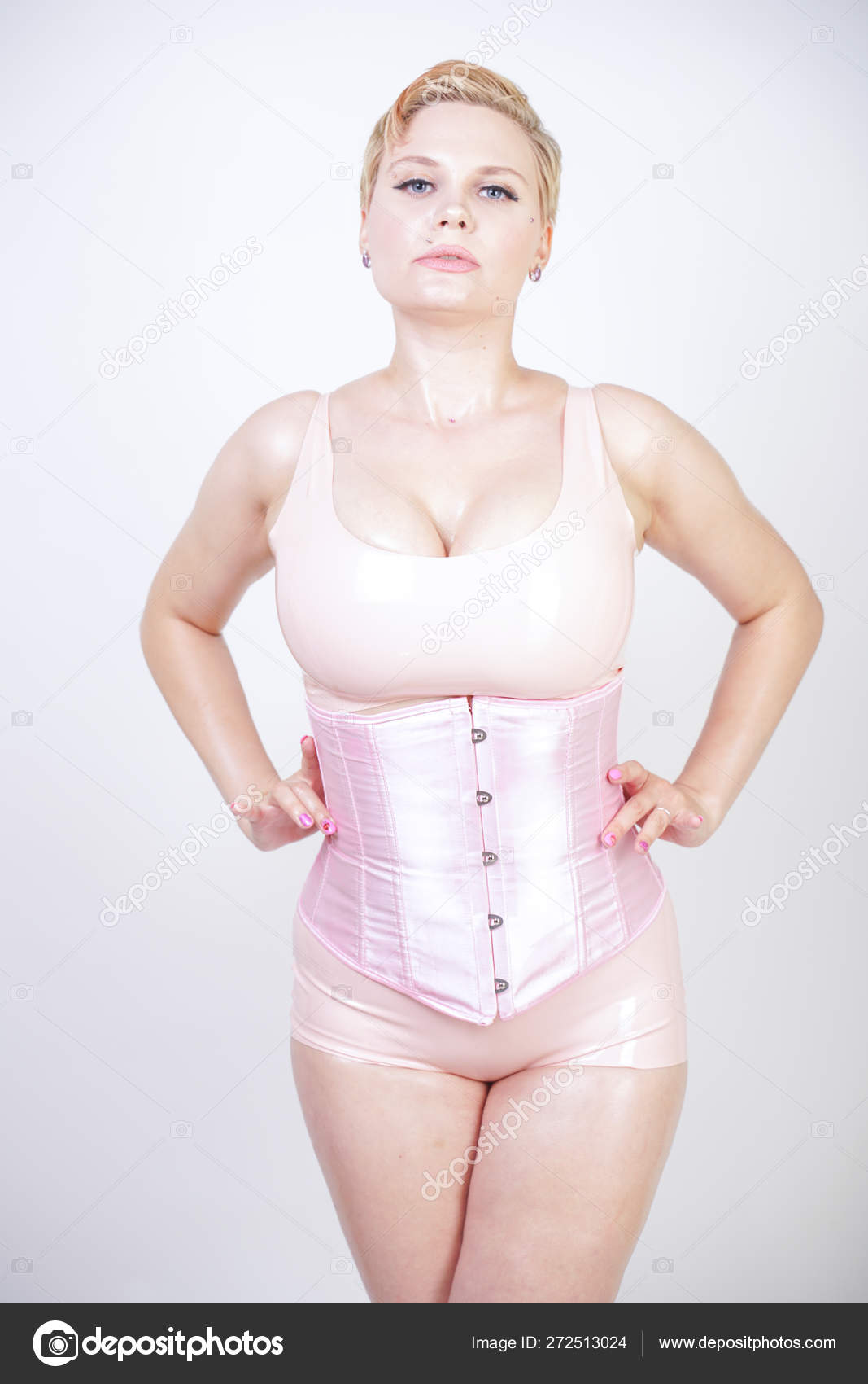 Curvy Sexy Short Haired Girl Pink Latex Suit Corset Stands Stock