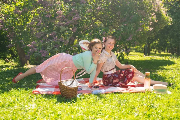 Zwei Hübsche Freundinnen Sitzen Auf Der Roten Decke Grünen Gras — Stockfoto