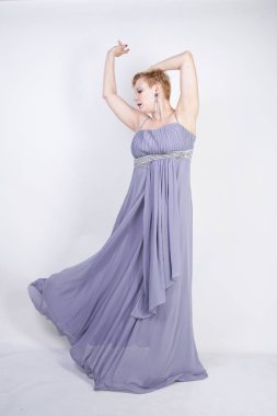 gri uzun elbise zarif kalın kadın. beyaz stüdyo arka plan üzerinde duran gece elbisesi güzel artı boyutu kadın. gri giysiler içinde kısa saç tombul kız tek başına poz.