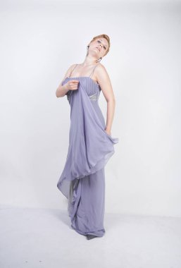 gri uzun elbise zarif kalın kadın. beyaz stüdyo arka plan üzerinde duran gece elbisesi güzel artı boyutu kadın. gri giysiler içinde kısa saç tombul kız tek başına poz.