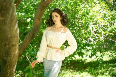 beyaz elbise güzel genç esmer kız şehir parkında ağacın gölgesinde sıcak güneşten gizlemek